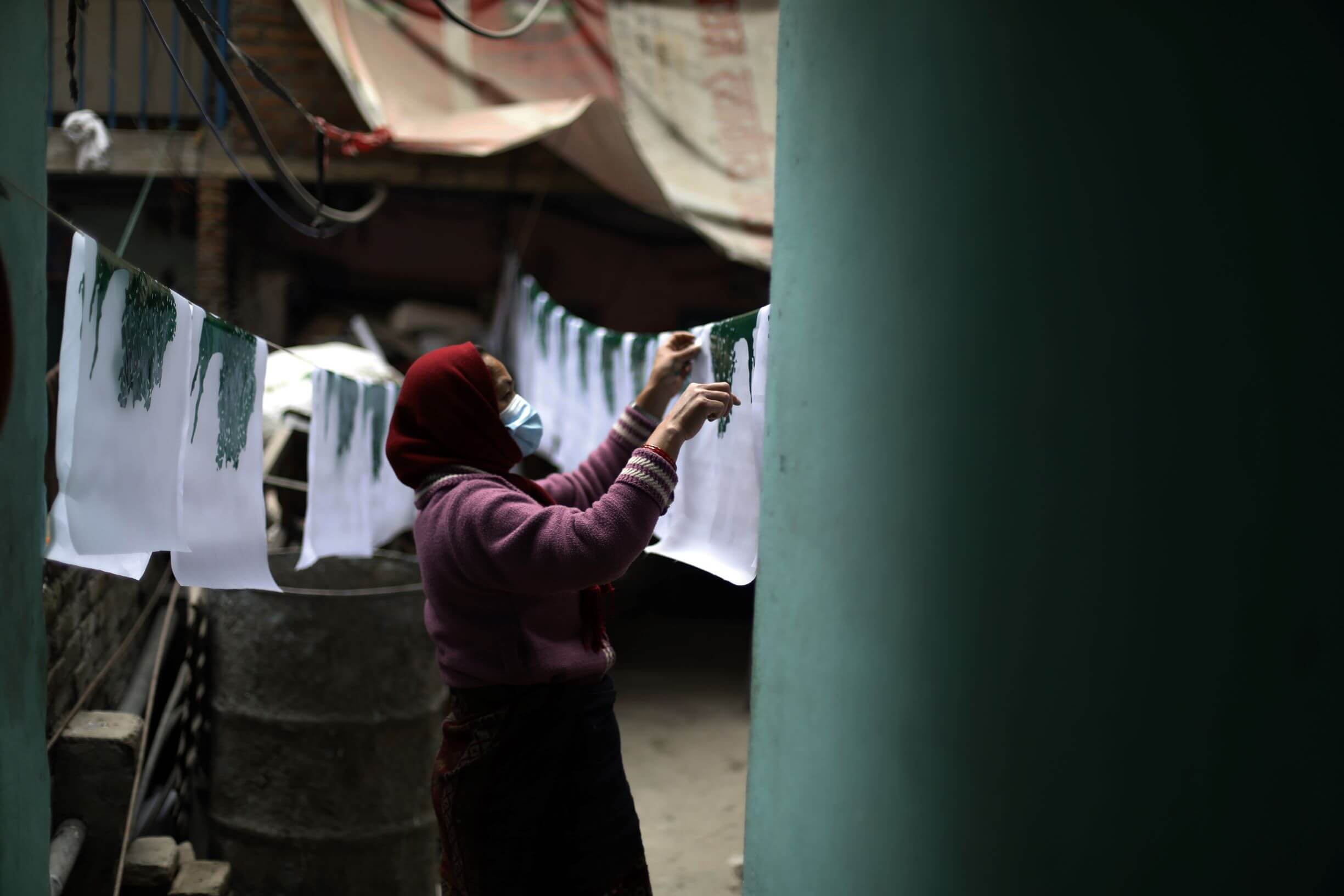 A woman hangs the flag to dry.