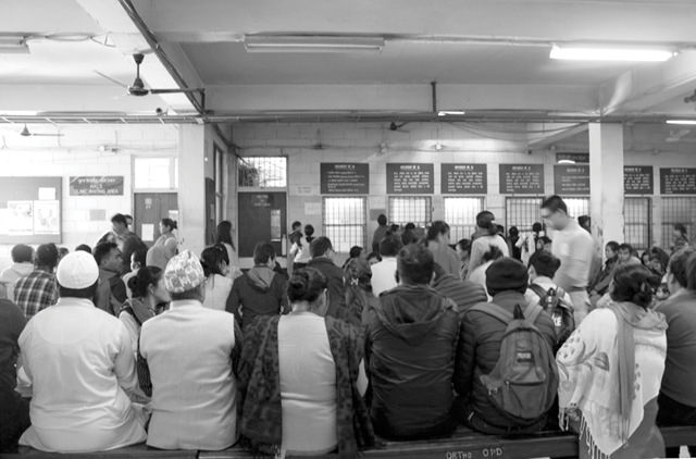 a group of people waiting in a hospital room