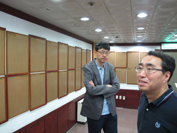 Hyankoreh editors at the newspaper's lobby where the names of 60,000 shareholders are engraved on the wall.