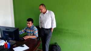 Ameet Dhakal with his technical manager at the Setopati office in Jhamsikhel earlier this month.