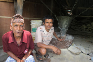 FATHER TO SON: Karna Thapaliya and his youngest son upgraded the traditional water mill of their ancestors to generate 5kW of electricity to sell to 26 households in the neighbourhood. 