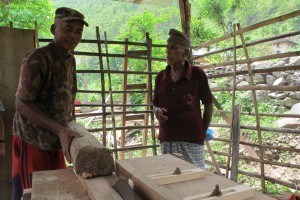 Krishna Shrestha (left) uses power generated by Karna Thapaliya's improved water mill to run a small furniture factory by the banks of the Rosi in Kavre.