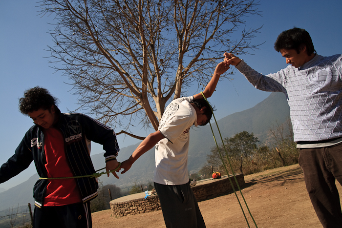  These boys attempt to pass looped ropes around a closed circle of their peers. Games such as this require communication and teamwork to complete, values which are reinforced by the instructors at the end of each activity. 