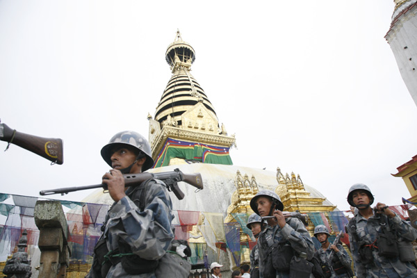 The newly renovated stupa shines in the background as the Armed Police march on. 