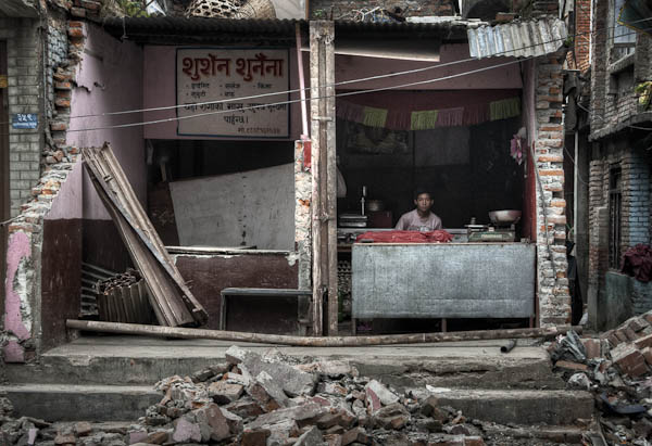 Open all hours: a shopkeeper in Budhanilkantha keeps his business running even after half the building was torn down (1 July)
