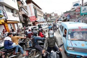 People on motorbikes, cars, public transport, walking come and go without order. Photo: Bikram Rai