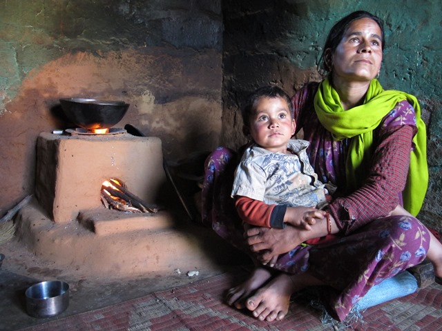 Gauri Devi Bhatt and her son in their kitchen with her Rs 200 smoke-free improved stove that has reduced her daily workload to gather firewood and educed lung and eye infections.