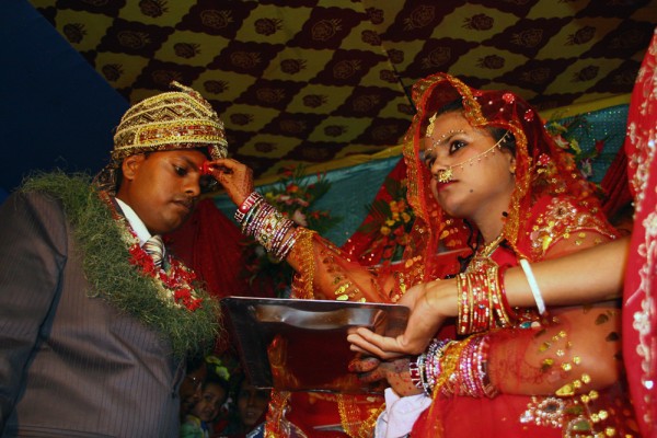 Finally the groom arrives and at the ceremony the bride puts tika on her groom's forehead to seal the agreement.