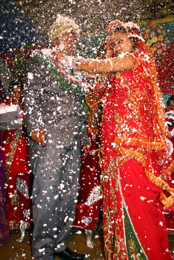 Congratulations to the newly-wed! Relatives and friends spray party foam over a the couple after they exchange rings and let the party start.
