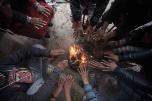 RAINY DAYS: Workers in a furniture factory huddle around a bonfire at Gyaneshwor.
