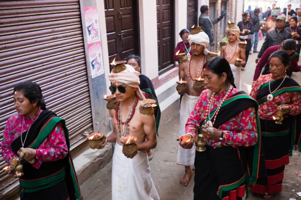 Hindu devotees portraying the Hindu god Madhav Narayan balance lit lamps on their head and body, during the Madhav Narayan festival on Saturday in Thecho.