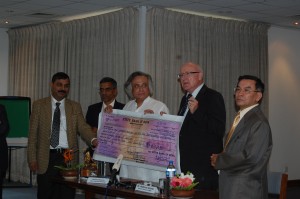 Minister Jai Shriram Ramesh hands over a check worth $160,000 to Dr. Andreas Schild, Director General of ICIMOD