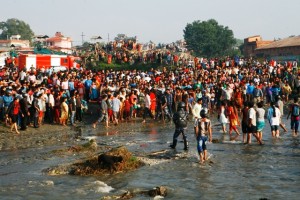 Locals gathered around the river bank near the crash site 