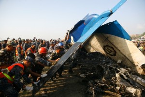 Men from the APF try to reposition the upside down plane. 
