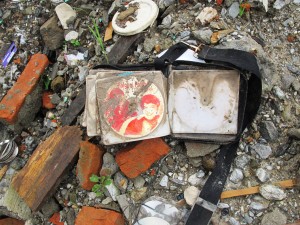 On the edges of the landslide, where some of the concrete-pillar houses are still standing, we saw this orphaned CD collection with the leaf turned to Phalguni Pathak.