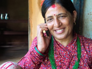 Sita Devi, wife of Surya Mohan Bastola, talking on her mobile phone. 