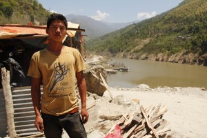 Lanka Tamang stands infront of a makeshift tent he built after his house was destroyed on Saturday. Pic: Bhrikuti Rai