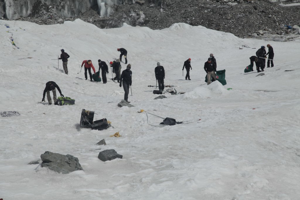 A multinational team cleaning up the Everest Base Camp. 