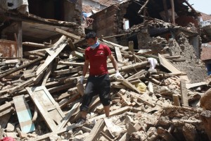 Upendra Maharjan standing on debris of his house Pic: Stéphane Huët