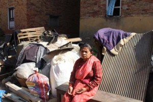Bhakti Maya Shrestha sits in front of her belongings salvaged from her collapsed house. Photo: Sahina Shrestha