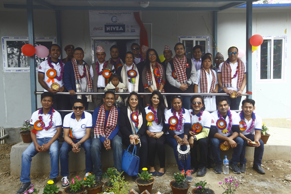 The Global Shapers Community Kathmandu team with eight year old Karishma. The idea of reconstructing the collapsed health post was born after Karishma's rescue from the rubble of her wrecked house by the team after the April 2015 earthquake . 
