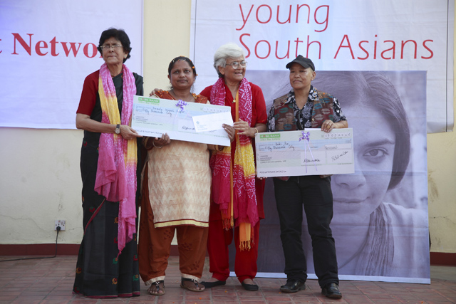 Women's right activist Abha Bhaiya and Kamla Bhasin hand over the Sangatee Grant Award to Nirmala Kumari Gupta and Badri Pun on Monday. Pic: Gopen Rai