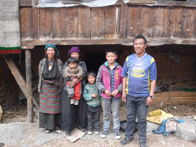 Dara Punjal Lama, (second from right) with his family in Tsum Valley from where he has to walk two days to his school in Philim several times a year across dangerous trails damaged by landslides.