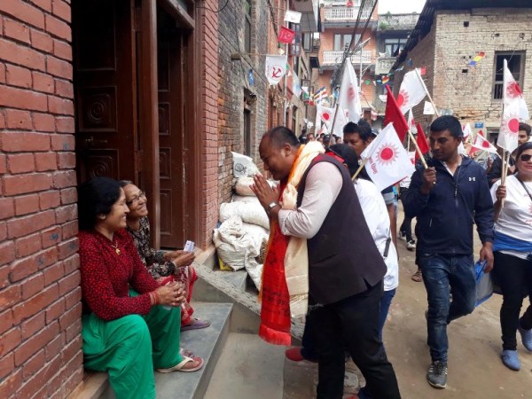 CPN-UML candidate Madansundar Shrestha visits locals of Madhyapur Thimi asking for their vote. Pic: RSS