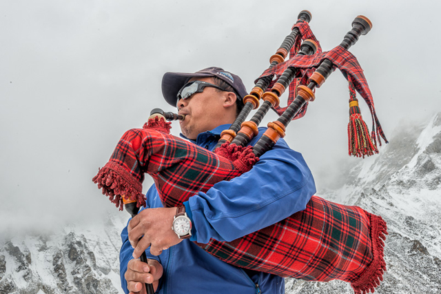 KEEPING WATCH: A Gurkha soldier in kilts and playing a bagpipe at Mt Everest Base Camp this month sporting a Loomes watch that will be auctioned to raise money for earthquake survivors in Nepal.